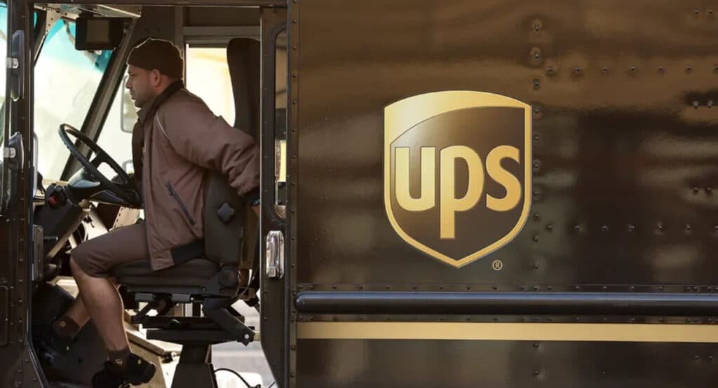 "UPS driver in truck, 2025 Amazon layoffs and Trump tariffs impact."