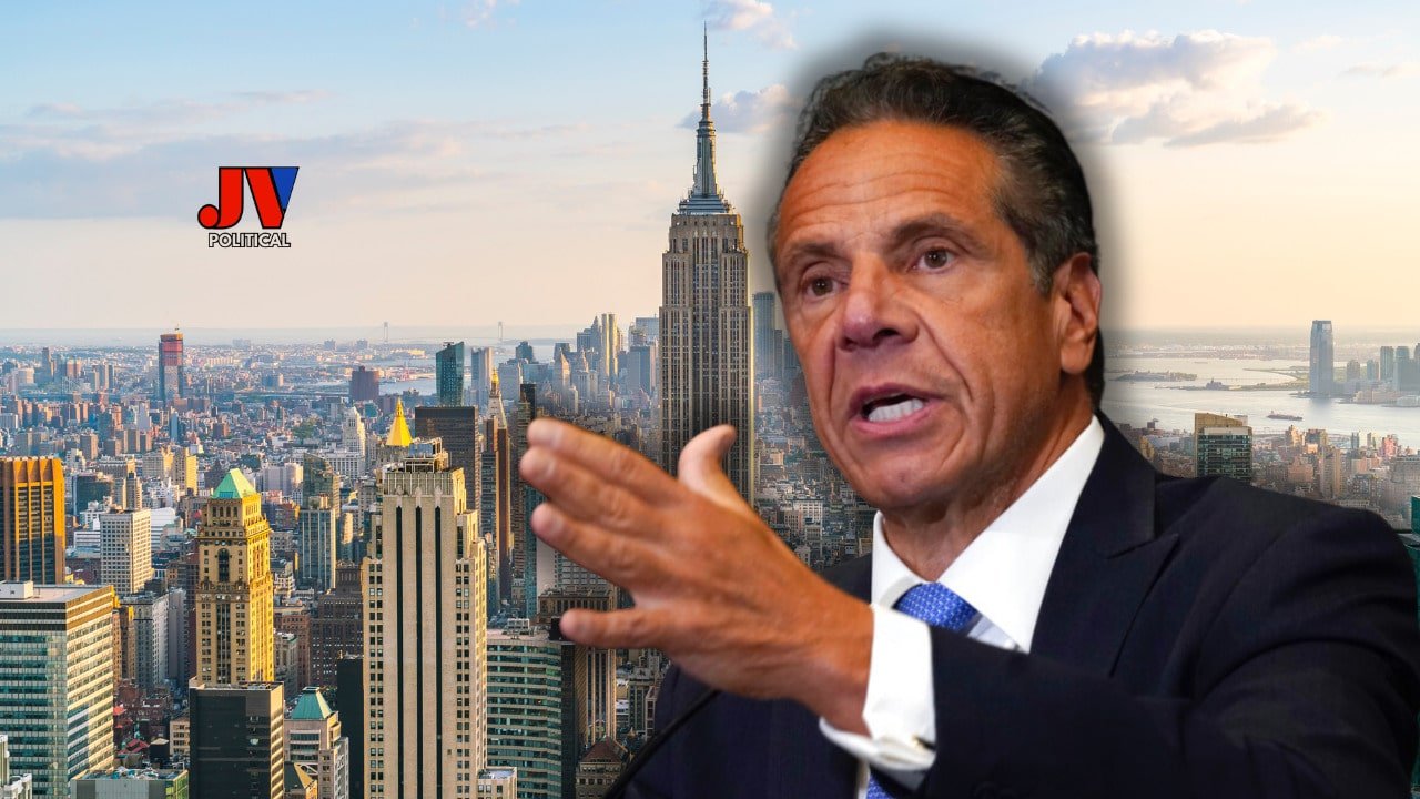 A fiery JV Political graphic shows Andrew Cuomo in a suit, gesturing intensely with a New York City skyline backdrop, featuring the Empire State Building glowing at sunset. The JV Political logo in bold red and blue hovers above, signaling breaking news. This image screams justice as Trump’s DOJ investigates Cuomo for his COVID nursing home lies— a huge MAGA win! 🗽🔥 #CuomoInvestigation #TrumpDOJ #MAGA #JusticeForNursingHomes #NewYorkScandal #AmericaFirst #DrainTheSwamp