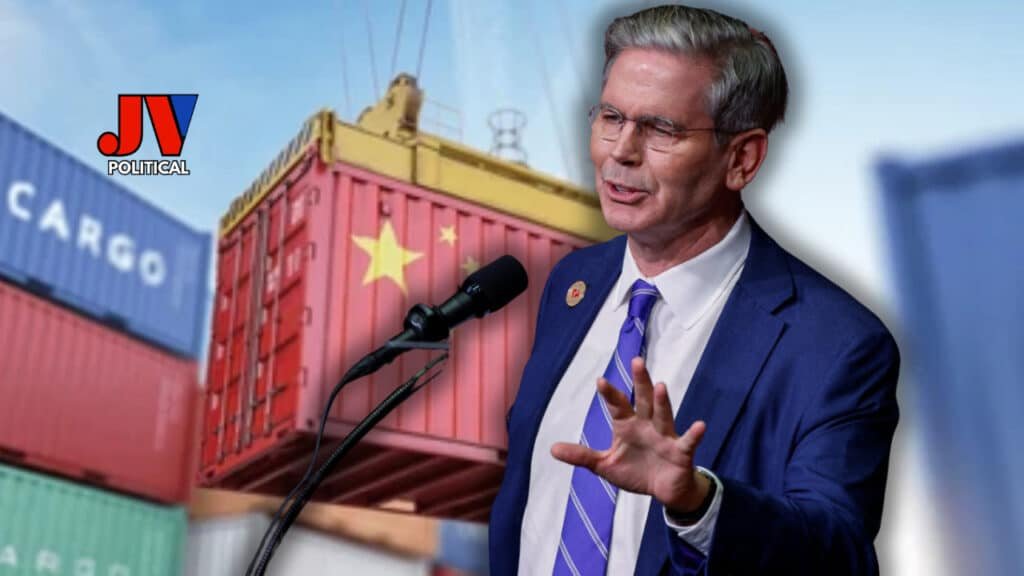 Scott Bessent in a sharp blue suit, gesturing confidently at a podium with mics 🎙️, standing in front of massive shipping containers marked with a Chinese flag 🇨🇳 and the word "CARGO." JV Political logo in the corner. He’s sealing the U.S.-China trade deal like a boss! 💼⚖️ #TradeWin #AmericaFirst #BessentDelivers