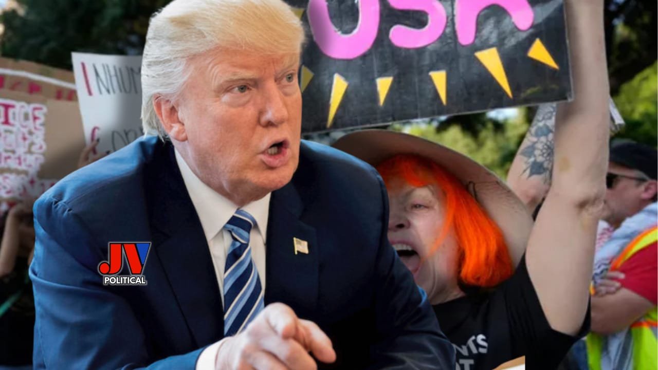 "President Donald Trump, rocking a sharp blue suit with the JVPolitical.com logo, passionately speaks at a rally, pointing forward with determination. Behind him, a vibrant protester with bright orange hair and a quirky hat holds a bold 'NO USA' sign, surrounded by a chaotic crowd of signs and energy—capturing the fiery clash of ideologies on June 14, 2025!" No Kings Protests